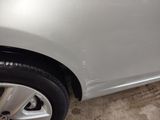a close up of a silver car with black rims