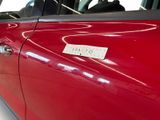 a sticker on the door of a red car