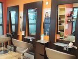 an image of a hair salon with chairs and mirrors