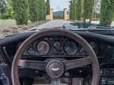 a steering wheel and dashboard of a car on the road