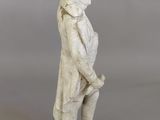 an image of a statue of a man with a hat and coat