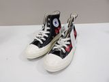 pair of black and white converses with red hearts on them
