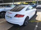 a white car parked in a parking lot next to other cars