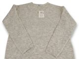 a grey sweater with a white label on it