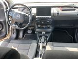 the interior of a car with a steering wheel and dashboard controls