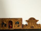 two pieces of art that are on a shelf