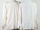 two mannequins with white shirts on them on a wooden stand