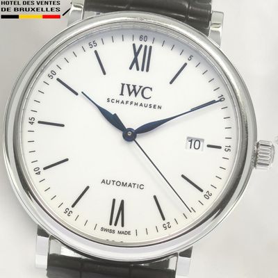 a close up of a wrist watch with a white dial