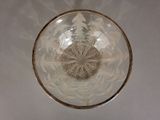 a clear glass bowl with a gold rim on a table