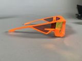an orange pair of sunglasses sitting on a table