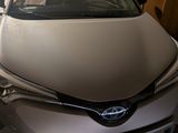 a car that is parked in a garage with other cars in the background