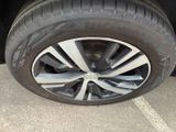 the tire of a car is shown on the pavement in the parking lot