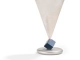 an image of a silver cup with a blue block in it
