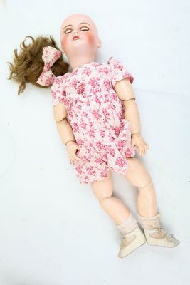 a doll that is laying down on the ground