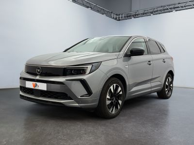 a silver suv parked in a large room with a white wall