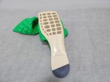 someone is wearing a pair of green shoes with a green leaf on the sole
