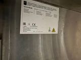 a sign on the side of a stainless steel refrigerator