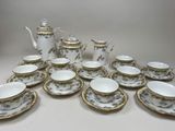 many cups and saucers that are sitting on the table