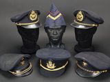 four hats and a hat stand on top of a mannequin head