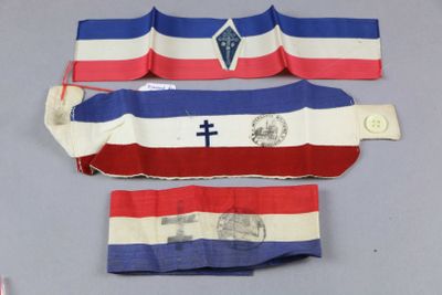 three pieces of red, white, and blue striped cloth with a cross on it