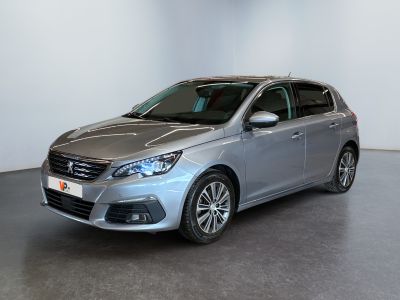 a silver car is parked in a room with a white wall