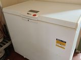 an image of a small white refrigerator in a room