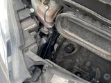 the engine of a car with its hood open and the hood down