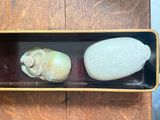 two rocks in a black box on a wooden table