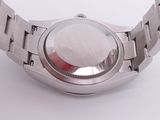 a close up of a wrist watch on a white surface