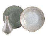 deux assiettes et un vase posés les uns à côté des autres