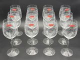 six empty wine glasses with red labels are lined up in a row