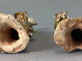 two vases that are sitting on a table