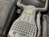 a bag with a remote and a cell phone inside of it