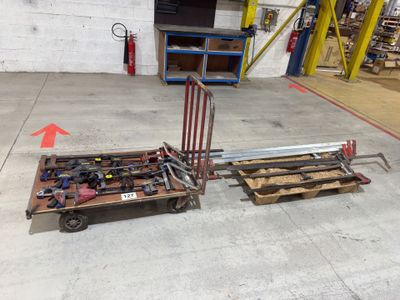 two wooden pallets with tools on them in a warehouse