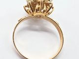 a close up of a gold ring with three diamonds on it