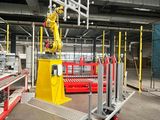 a robot that is working on a machine in a factory