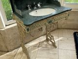 a sink in the corner of a room with a large window