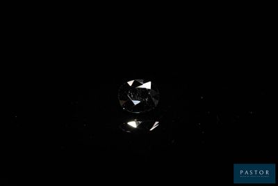 an image of a diamond in the dark on a black surface