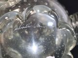 a glass vase with a heart shaped decoration on it