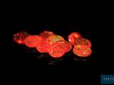 several red fire oplite stones are lit up in the dark