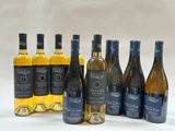 several bottles of wine are lined up on a white surface