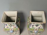 two vases that are sitting on a table