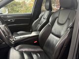 the interior of a car with black leather seats and a steering wheel