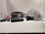 a white shelf with a bunch of wires on top of it
