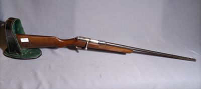 an old rifle with a wooden handle and a leather case