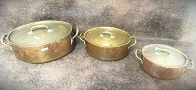 three pots and pans sitting on a table