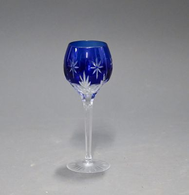 a blue wine glass sitting on top of a table