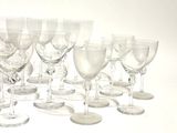 a lot of wine glasses that are lined up together