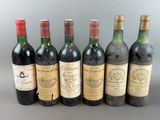 six bottles of wine are lined up in a row on a table