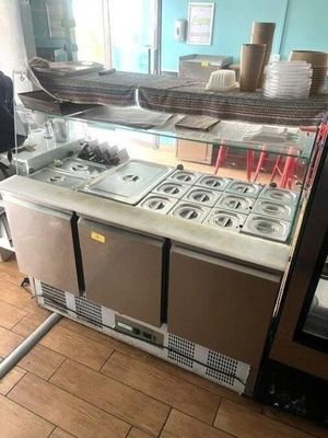 an image of a kitchen with a counter and a refrigerator